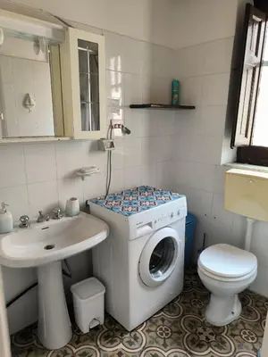 a bathroom with a washing machine and a sink at Casa Trinita in Castellammare del Golfo