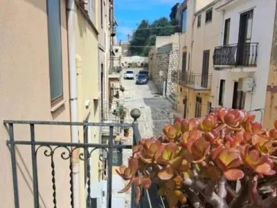 a potted plant on a balcony of a building at Casa Trinita in Castellammare del Golfo
