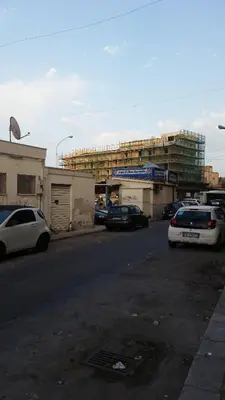 a parking lot with cars parked on the side of a street at Casa Marta in Palermo
