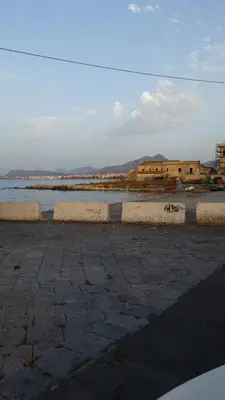 an empty parking lot next to a body of water at Casa Marta in Palermo