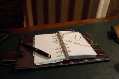 a notebook with a pen on top of a table at Palermo Gallery in Palermo