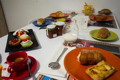 a table with plates of food on a table at Palermo Gallery in Palermo