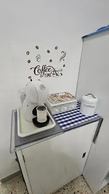 a table with a tea kettle and a box of donuts at Le Terrazze in Carini