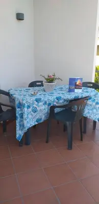 a table with a blue table cloth on it with two chairs at Le Terrazze in Carini