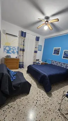 a bedroom with a bed and a ceiling fan at Le Terrazze in Carini
