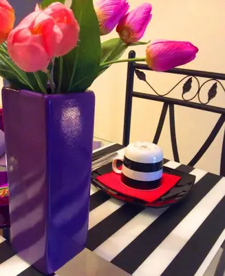 a blue vase with a hat and flowers on a table at B&B Montecarlo in Palermo