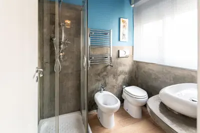 a bathroom with a toilet and a sink and a shower at B&B Montecarlo in Palermo