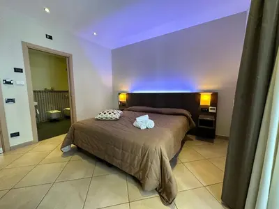 a bedroom with a bed with two pillows on it at BB 10 Serpotta - Palazzo Riolo & Restaurant in Palermo