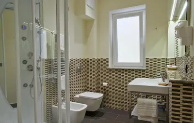 a bathroom with a toilet and a sink and a shower at BB 10 Serpotta - Palazzo Riolo & Restaurant in Palermo