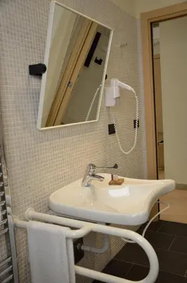 a bathroom with a sink and a mirror at BB 10 Serpotta - Palazzo Riolo & Restaurant in Palermo