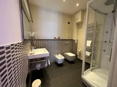 a bathroom with a sink and a toilet and a shower at BB 10 Serpotta - Palazzo Riolo & Restaurant in Palermo