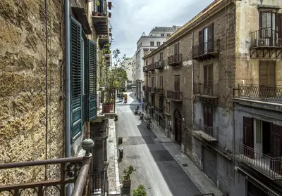 an empty street in an alley between buildings at Palazzo Filangeri di Amorosa in Palermo