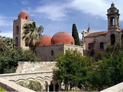 an old building with domes and a clock tower at Palazzo Filangeri di Amorosa in Palermo