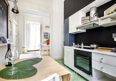 a kitchen with a table with a wine glass on it at Palazzo Filangeri di Amorosa in Palermo