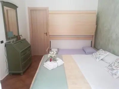 a small bedroom with two beds and a mirror at La casetta alla Vucciria in Palermo