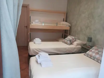 two beds in a small room with towels on them at La casetta alla Vucciria in Palermo