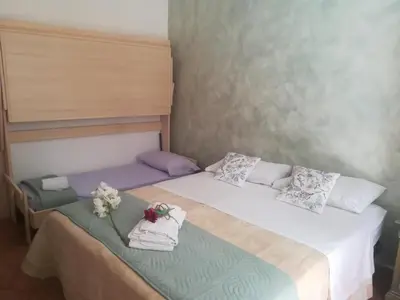 a bedroom with two beds with towels on them at La casetta alla Vucciria in Palermo