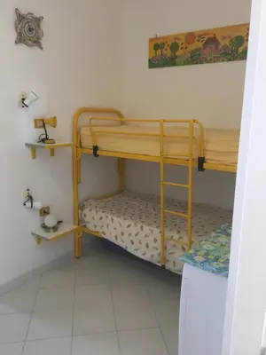 a bedroom with two bunk beds in a room at Casa Del Mulino a Vento in San Vito lo Capo