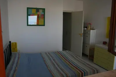a bedroom with a bed and a dresser at Casa Del Mulino a Vento in San Vito lo Capo