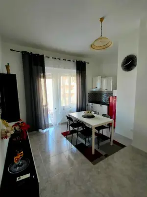 a living room with a table and a kitchen at Casa Sciuti in Palermo