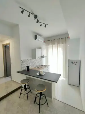 a kitchen with a counter and two bar stools at Casa Sciuti in Palermo