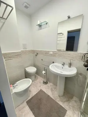 a bathroom with a sink and a toilet and a mirror at Casa Sciuti in Palermo
