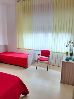 a bedroom with a red bed and a red chair at Casa Le Bellezze del Golfo in Castellammare del Golfo
