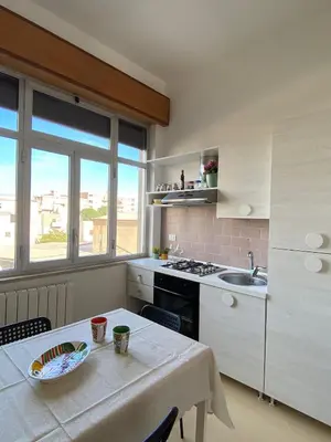 a kitchen with a table and a sink and a stove at Casa Le Bellezze del Golfo in Castellammare del Golfo
