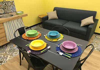 a table with plates on it in a living room at NA' SCICCHERIA HOME in Castellammare del Golfo