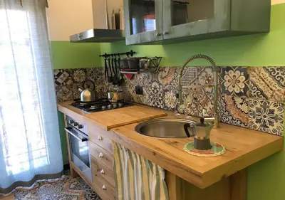 a kitchen with a sink and a stove at NA' SCICCHERIA HOME in Castellammare del Golfo