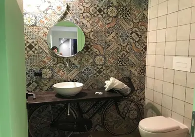 a bathroom with a sink and a toilet and a mirror at NA' SCICCHERIA HOME in Castellammare del Golfo