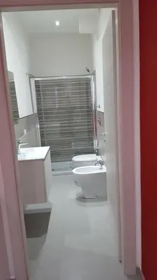 a bathroom with two sinks and a toilet and a tub at L'isola del sole in Castelluzzo