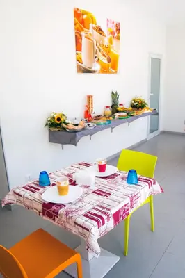 a table with two chairs and a table with a tablecloth at L'isola del sole in Castelluzzo