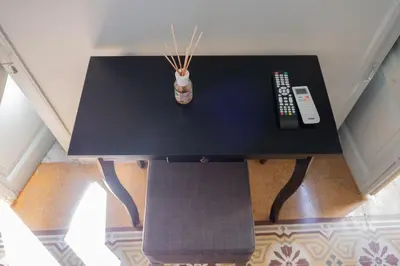 a black table with a remote control and a bottle on it at Al teatro Massimo in Palermo
