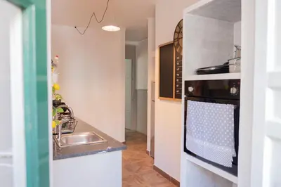 a kitchen with a sink and a stove at Al teatro Massimo in Palermo