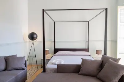a bedroom with a bed and a couch at Al teatro Massimo in Palermo