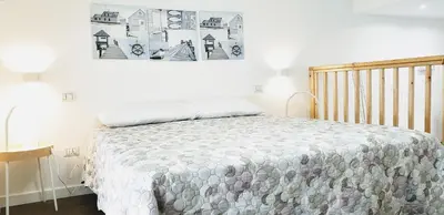 a bedroom with a bed and a picture on the wall at Sciabika Home - Edificio Eolie in Castellammare del Golfo