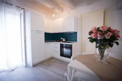 a kitchen with a table with a vase of flowers on it at Sciabika Home - Edificio Eolie in Castellammare del Golfo