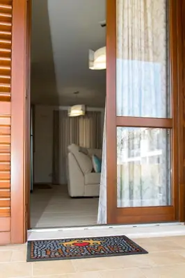 a door leading to a living room with a couch at Casa Vacanze Fontana in San Vito lo Capo