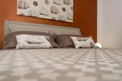 a bedroom with a bed with two pillows on it at Casa Vacanze Fontana in San Vito lo Capo
