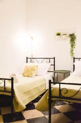 a bedroom with a bed and two side tables at Casa Jolanda B&B in Palermo