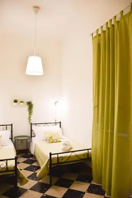 a bedroom with a bed and a green curtain at Casa Jolanda B&B in Palermo