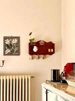 a kitchen with a radiator and a red shelf at Casa Jolanda B&B in Palermo