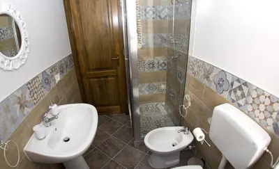 a bathroom with a sink and a toilet at Reginella B&B Palermo in Palermo