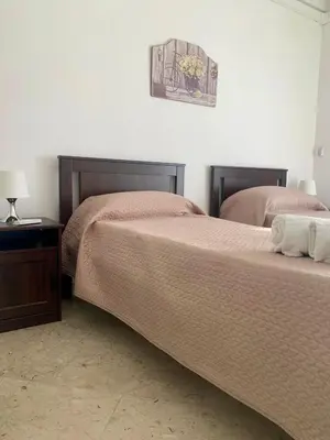 two beds sitting next to each other in a bedroom at Appartamento al centro vicino il porto in Palermo