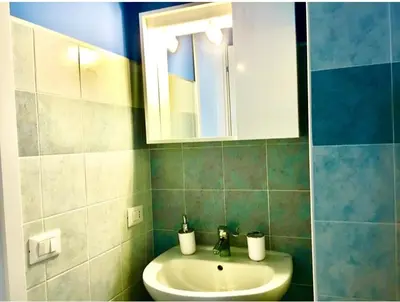 a bathroom with a sink and a mirror at Appartamento al centro vicino il porto in Palermo