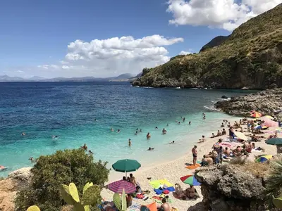 a group of people in the water at a beach at Casa turiddu Makari in Castelluzzo