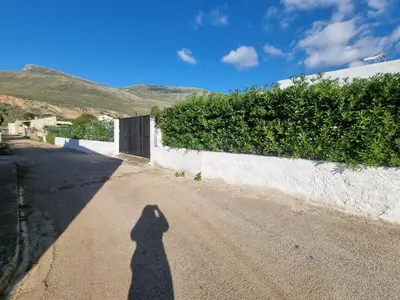 a shadow of a person walking down a road at Casa turiddu Makari in Castelluzzo