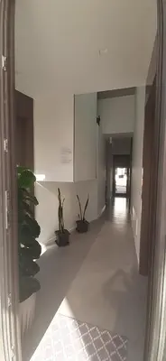 a hallway with potted plants in a building at Patio 101 