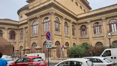 a large building with cars parked in front of it at Le Stelle del Massimo in Palermo